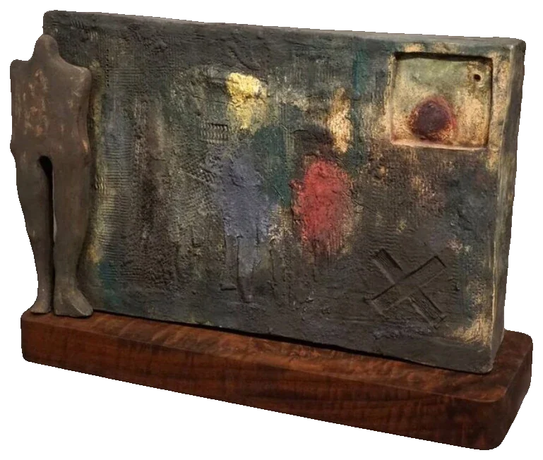 Untitled (ceramic relief), 2015. Ceramic. Ceramic relief panel with a standing figure and patches of red, blue and ochre, set on a wooden base.