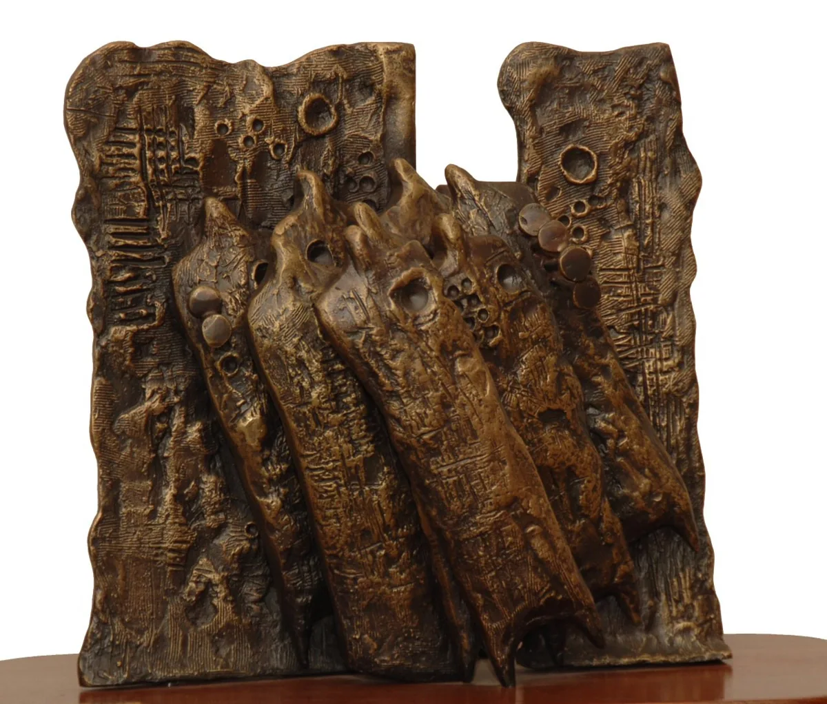 Bronze A14, 2007–2008. Bronze. Bronze relief of a tall wall of leaning, textured figures, on a wooden base.