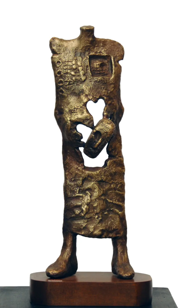 Bronze A3, 2007–2008. Bronze. Tall textured bronze figure with a heart-shaped opening in its chest, holding a smaller figure, on a wooden base.