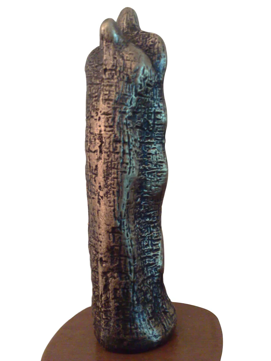 Bronze A6, 2007–2008. Bronze. Tall, column-like bronze of two figures pressed together, its surface incised with marks like script.