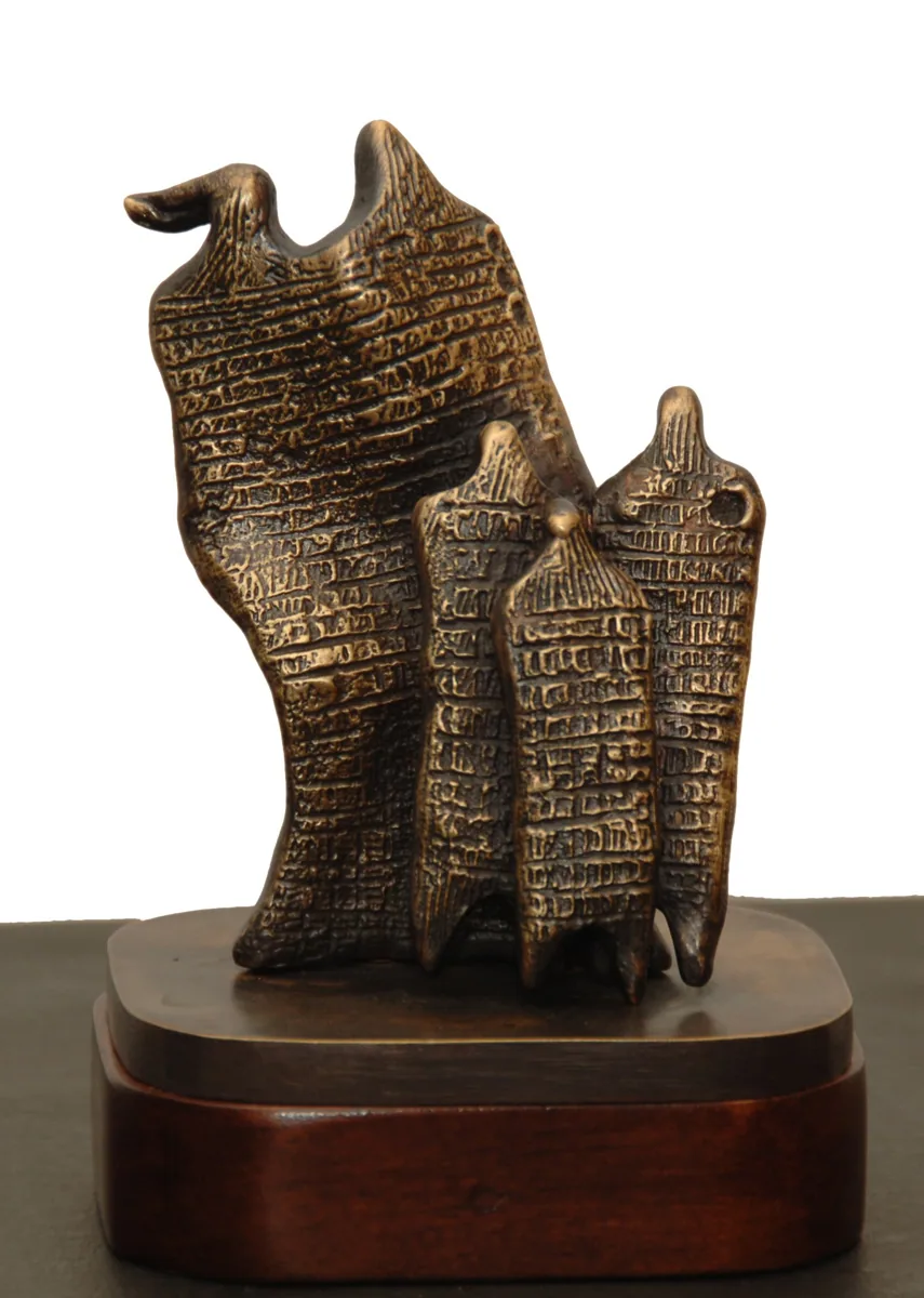 Bronze B26, 2009–2010. Bronze. Bronze of a group of textured, cloaked figures beneath a rising wall-like form, on a wooden base.