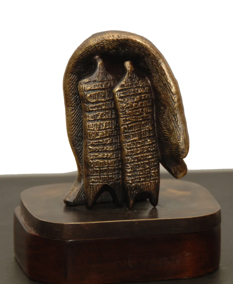 Bronze B29, 2009–2010. Bronze. Bronze of two textured figures sheltered beneath a curving hood-like form, on a wooden base.
