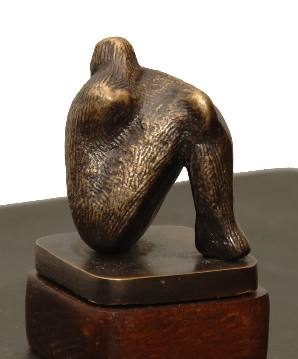 Bronze B33, 2009–2010. Bronze. Bronze of a crouching figure folded over its knees, on a wooden plinth.